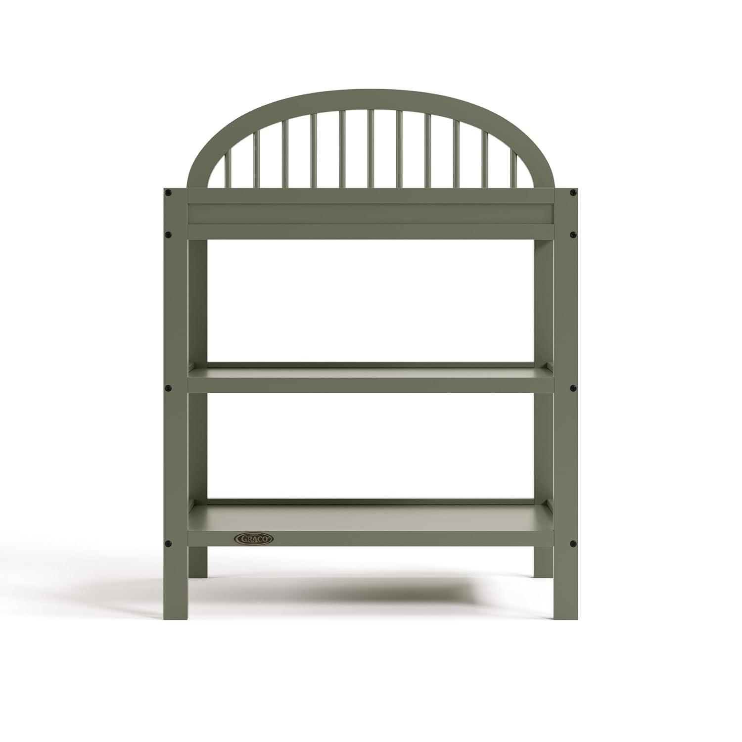 imageGraco Olivia Changing Table with WaterResistant Changing Pad Driftwood GREENGUARD Gold Certified Includes Bonus WaterResistant Changing Pad with Safety Strap 2 Open Shelves Stylish DesignOlive