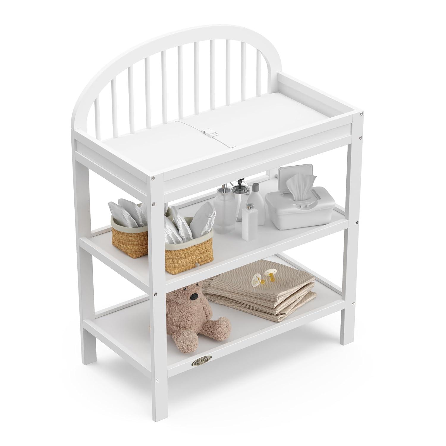 imageGraco Olivia Changing Table with WaterResistant Changing Pad Driftwood GREENGUARD Gold Certified Includes Bonus WaterResistant Changing Pad with Safety Strap 2 Open Shelves Stylish DesignWhite