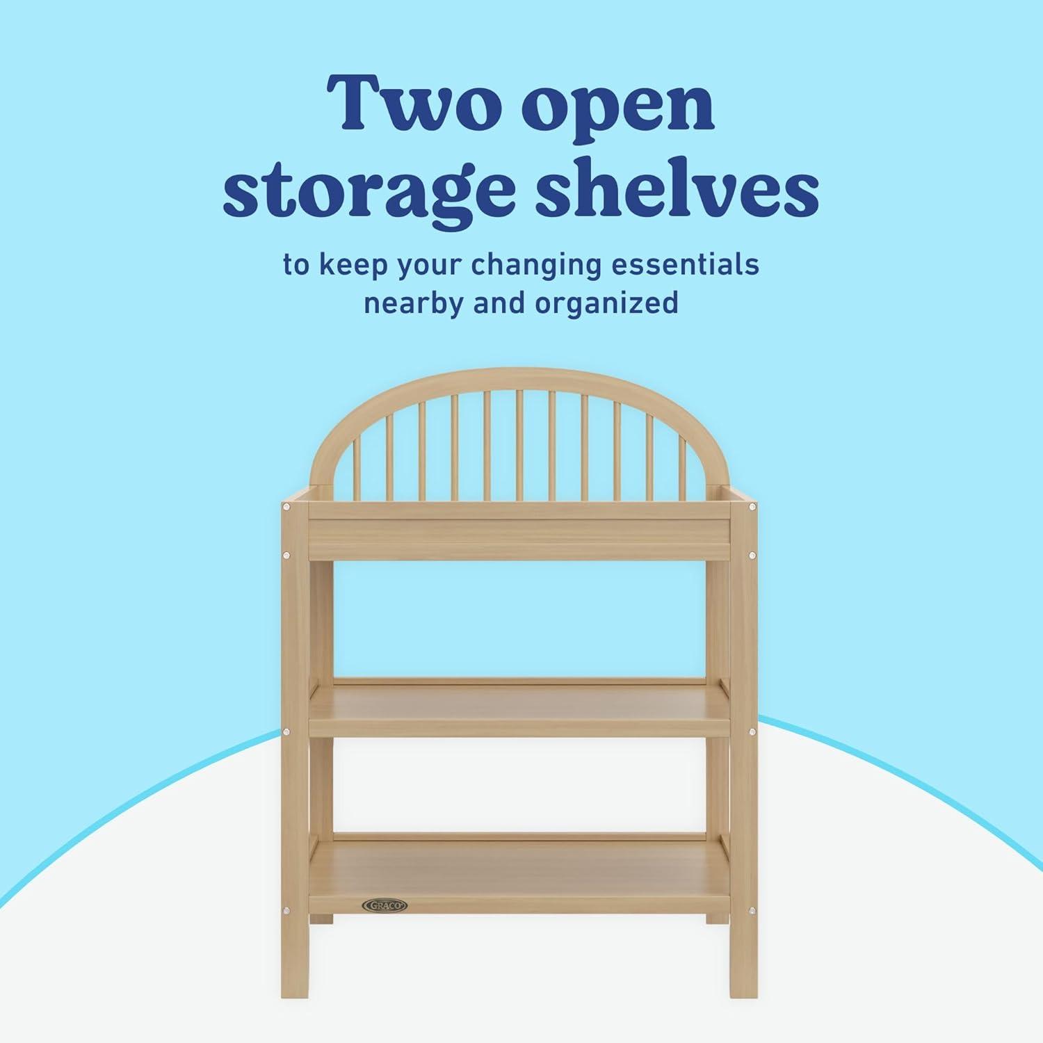 imageGraco Olivia Changing Table with WaterResistant Changing Pad Driftwood GREENGUARD Gold Certified Includes Bonus WaterResistant Changing Pad with Safety Strap 2 Open Shelves Stylish DesignDriftwood