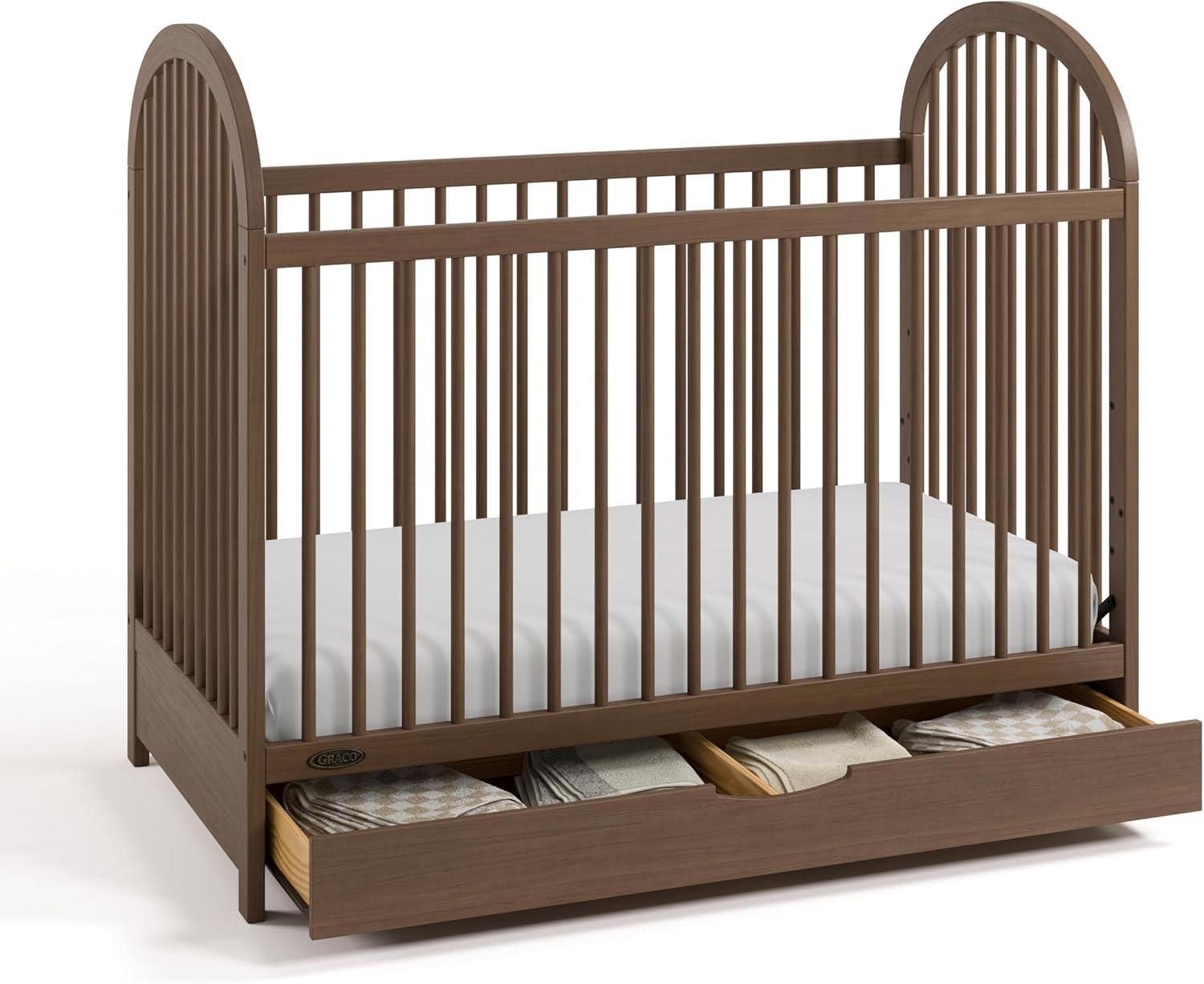 imageGraco Olivia Convertible Crib Black GREENGUARD Gold Certified 100 Solid Wood Fits Standard Crib Mattress Converts to Toddler Bed and Daybed 4 Adjustable Mattress HeightsHazelnut