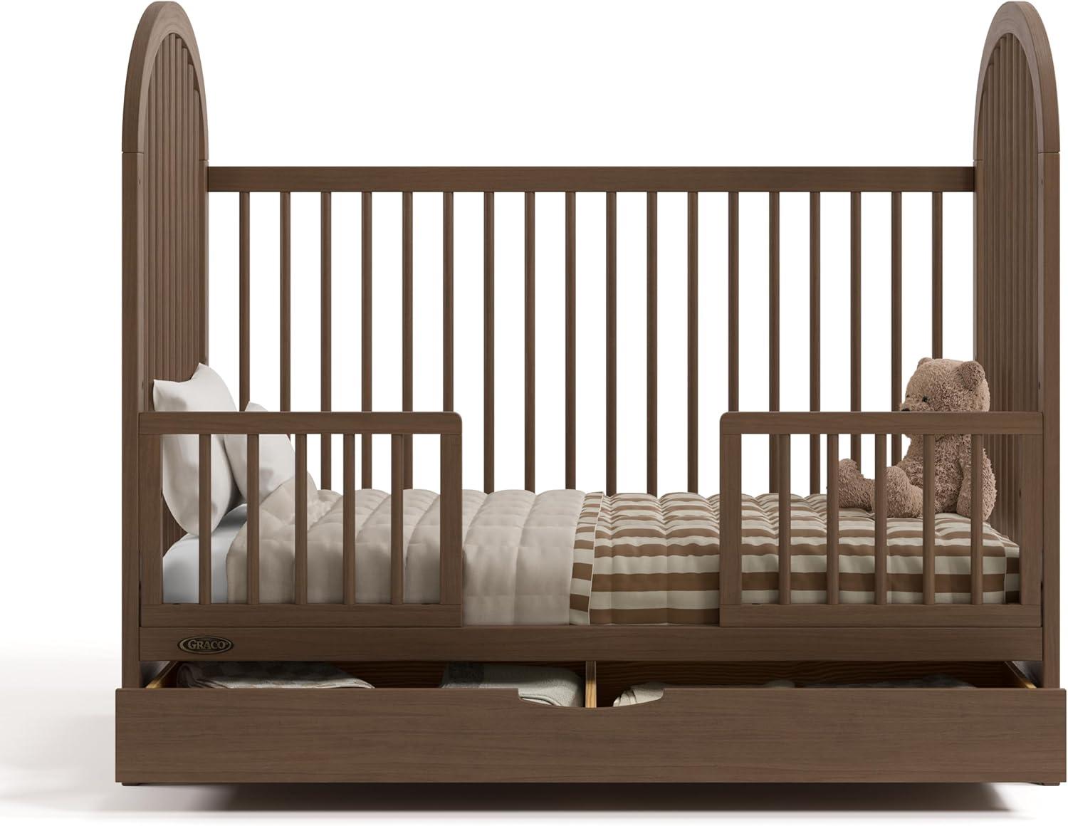 imageGraco Olivia Convertible Crib Black GREENGUARD Gold Certified 100 Solid Wood Fits Standard Crib Mattress Converts to Toddler Bed and Daybed 4 Adjustable Mattress HeightsHazelnut