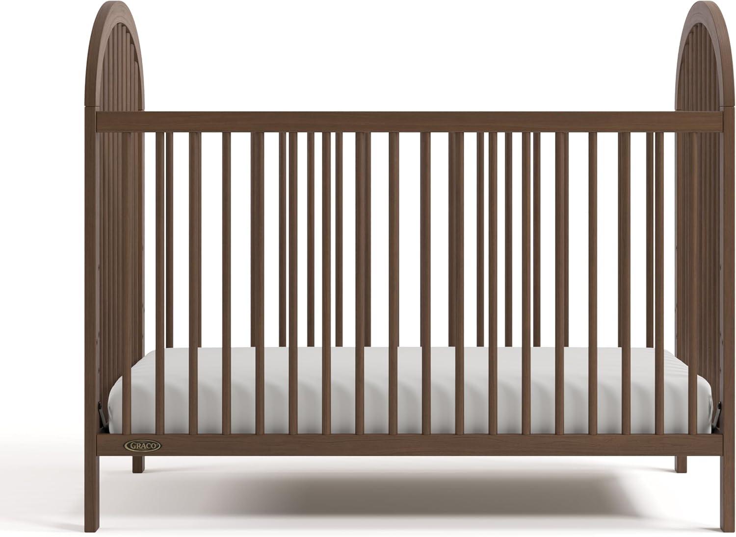imageGraco Olivia Convertible Crib Black GREENGUARD Gold Certified 100 Solid Wood Fits Standard Crib Mattress Converts to Toddler Bed and Daybed 4 Adjustable Mattress HeightsHazelnut