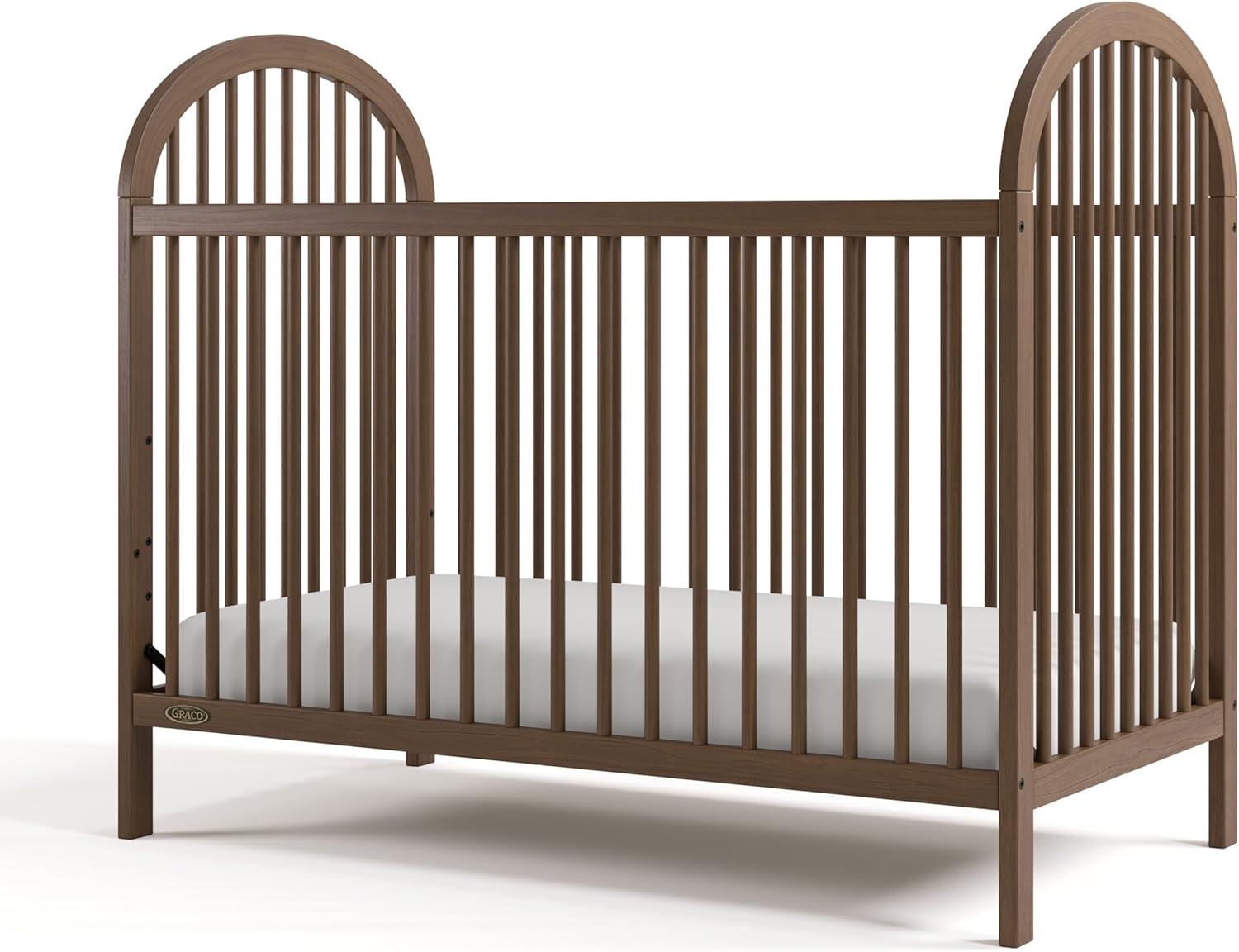imageGraco Olivia Convertible Crib Black GREENGUARD Gold Certified 100 Solid Wood Fits Standard Crib Mattress Converts to Toddler Bed and Daybed 4 Adjustable Mattress HeightsHazelnut