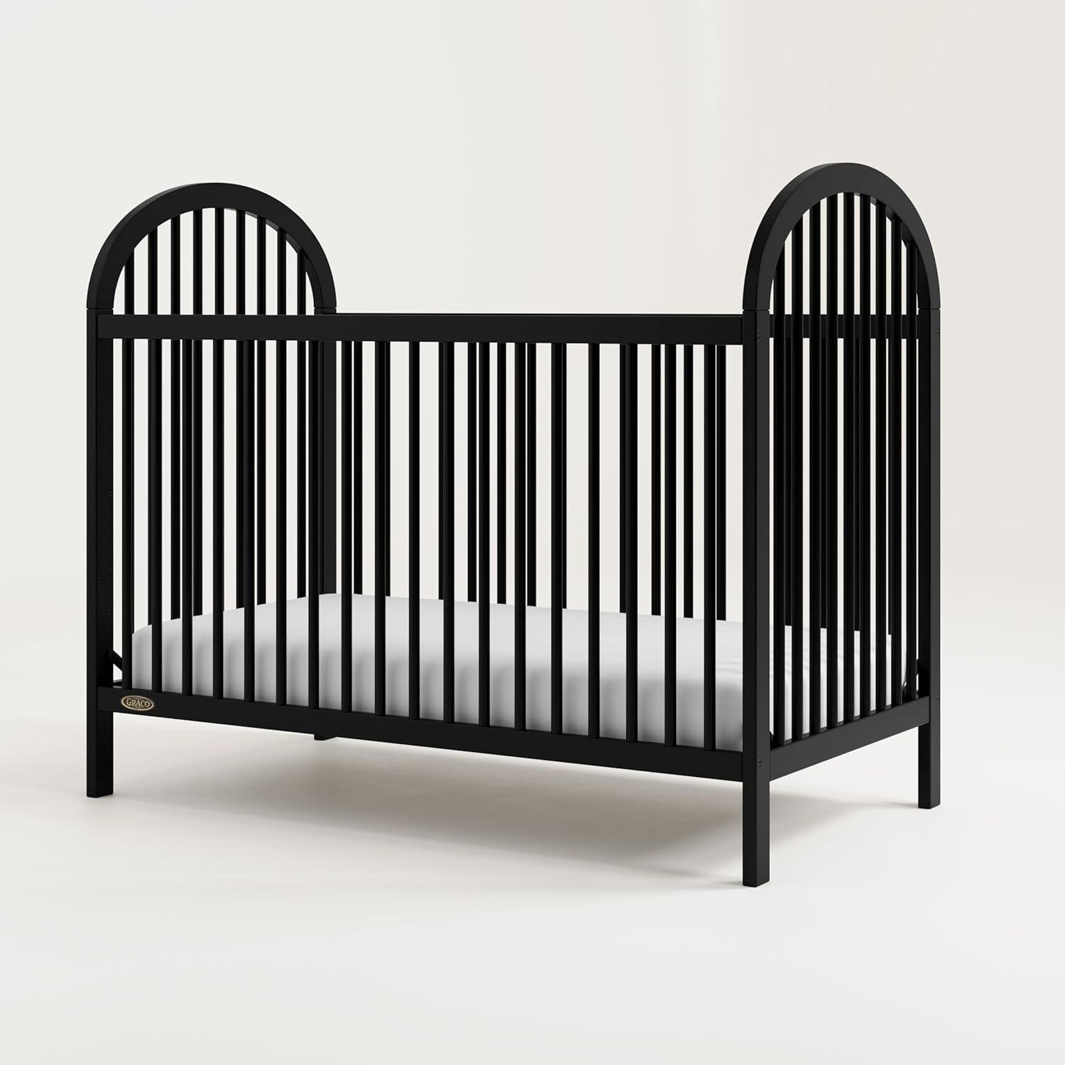 imageGraco Olivia Convertible Crib Hazelnut GREENGUARD Gold Certified 100 Solid Wood Fits Standard Crib Mattress Converts to Toddler Bed and Daybed 4 Adjustable Mattress HeightsBlack