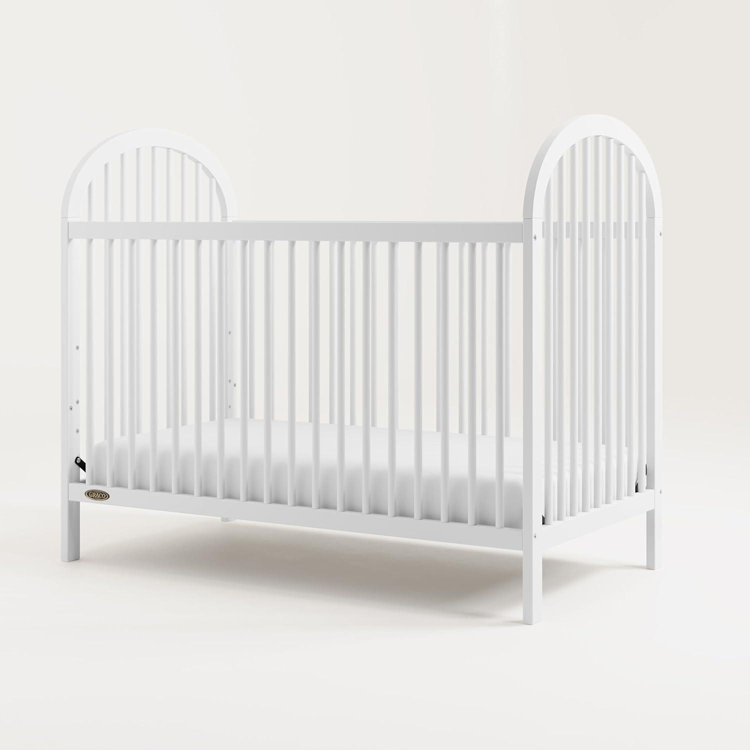 imageGraco Olivia Convertible Crib Hazelnut GREENGUARD Gold Certified 100 Solid Wood Fits Standard Crib Mattress Converts to Toddler Bed and Daybed 4 Adjustable Mattress HeightsWhite