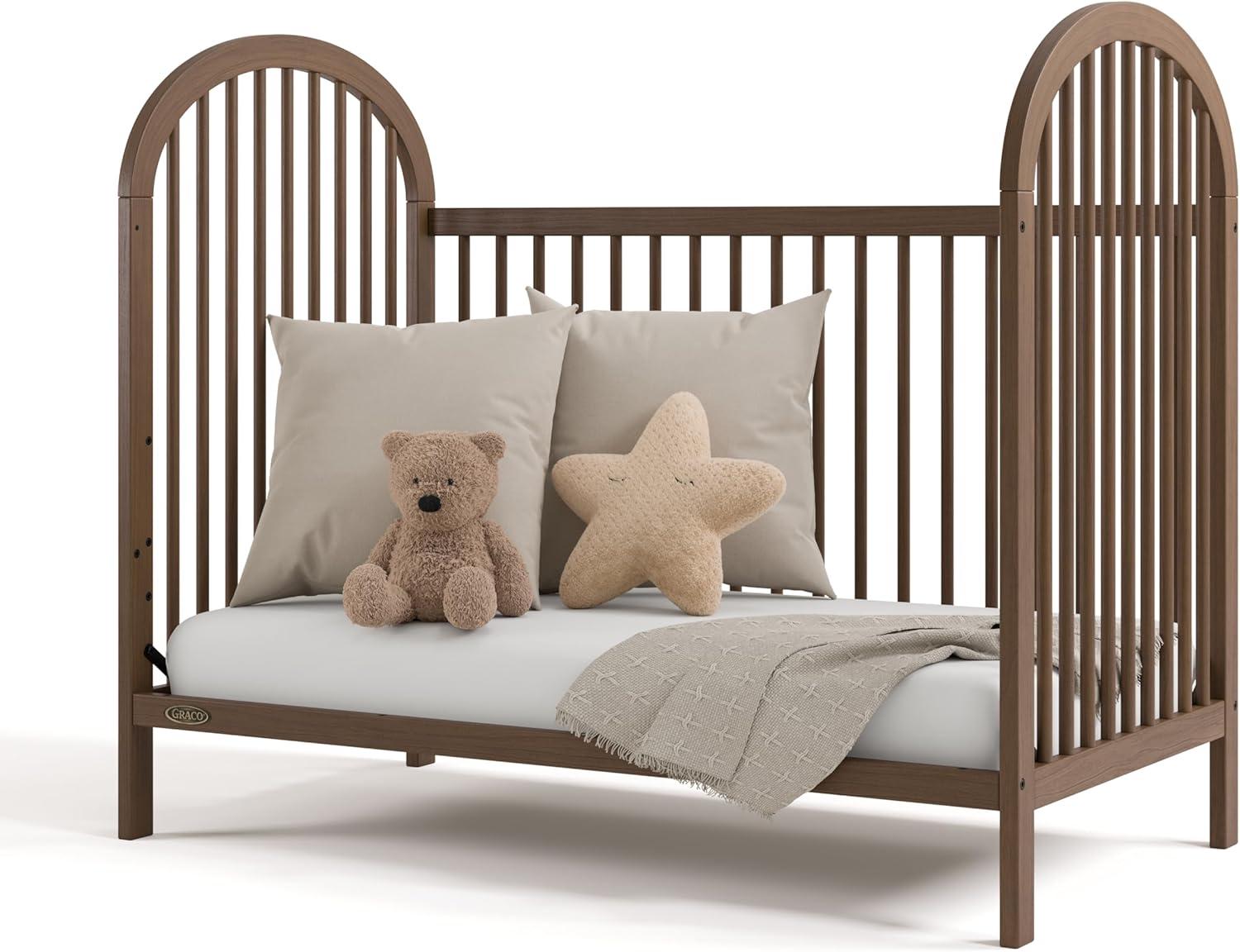 imageGraco Olivia Convertible Crib Hazelnut GREENGUARD Gold Certified 100 Solid Wood Fits Standard Crib Mattress Converts to Toddler Bed and Daybed 4 Adjustable Mattress HeightsHazelnut