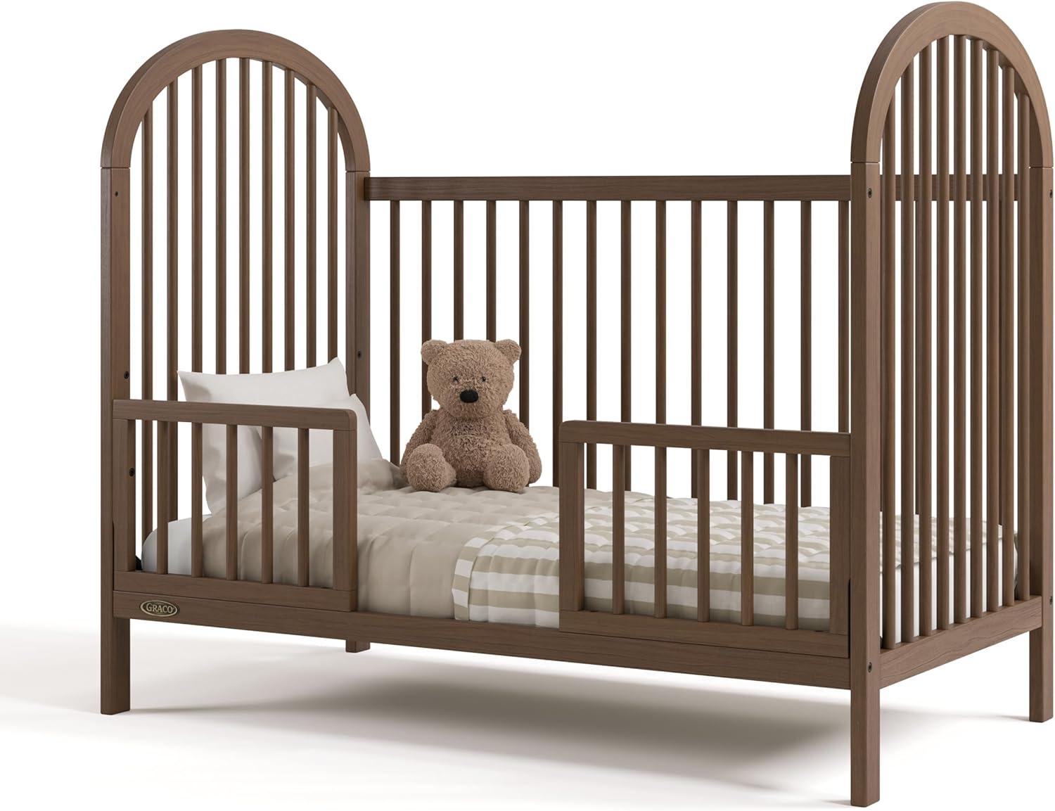 imageGraco Olivia Convertible Crib Hazelnut GREENGUARD Gold Certified 100 Solid Wood Fits Standard Crib Mattress Converts to Toddler Bed and Daybed 4 Adjustable Mattress HeightsHazelnut