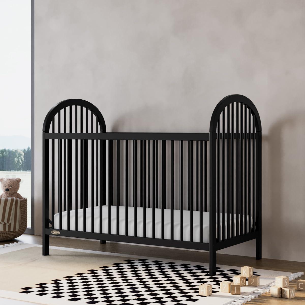 imageGraco Olivia Convertible Crib Hazelnut GREENGUARD Gold Certified 100 Solid Wood Fits Standard Crib Mattress Converts to Toddler Bed and Daybed 4 Adjustable Mattress HeightsBlack