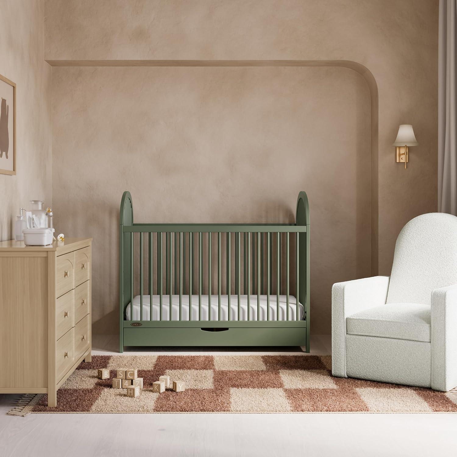 imageGraco Olivia Convertible Crib Hazelnut GREENGUARD Gold Certified 100 Solid Wood Fits Standard Crib Mattress Converts to Toddler Bed and Daybed 4 Adjustable Mattress HeightsOlive