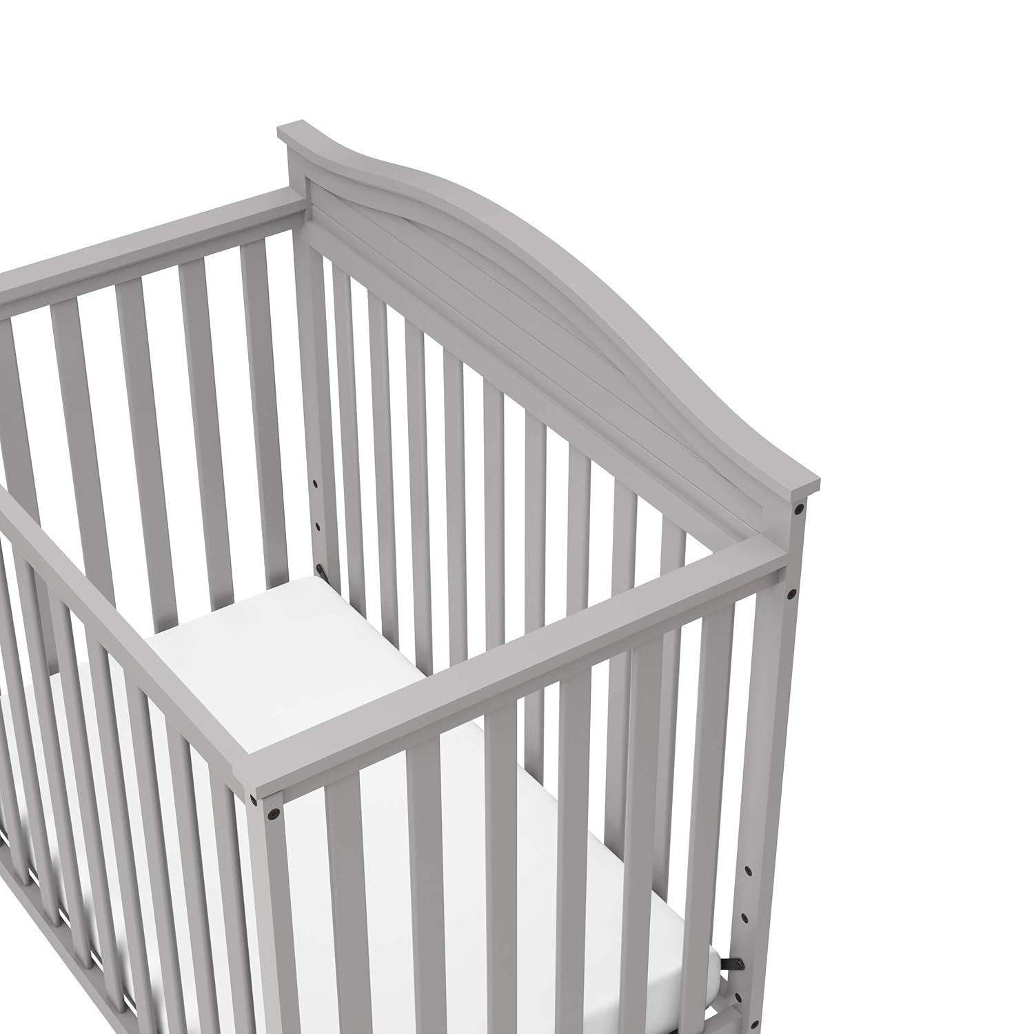 imageGraco Stella 4in1 Convertible Mini Crib with Bonus Mattress Pebble Gray Includes Bonus 275 Inch Thick Mattress with WaterResistant Cover Converts to Twin Bed Ideal Crib for Small SpacesPebble Gray