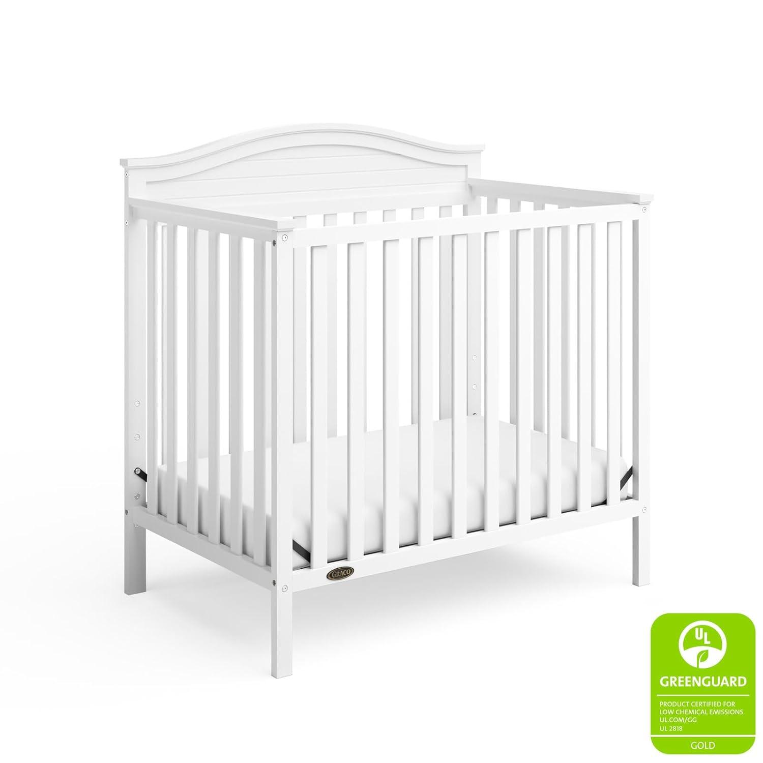 imageGraco Stella 4in1 Convertible Mini Crib with Bonus Mattress Pebble Gray Includes Bonus 275 Inch Thick Mattress with WaterResistant Cover Converts to Twin Bed Ideal Crib for Small SpacesWhite