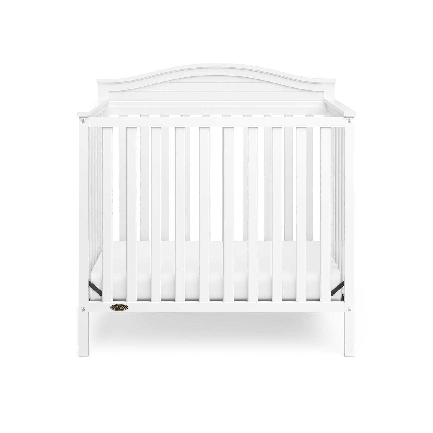 imageGraco Stella 4in1 Convertible Mini Crib with Bonus Mattress Pebble Gray Includes Bonus 275 Inch Thick Mattress with WaterResistant Cover Converts to Twin Bed Ideal Crib for Small SpacesWhite
