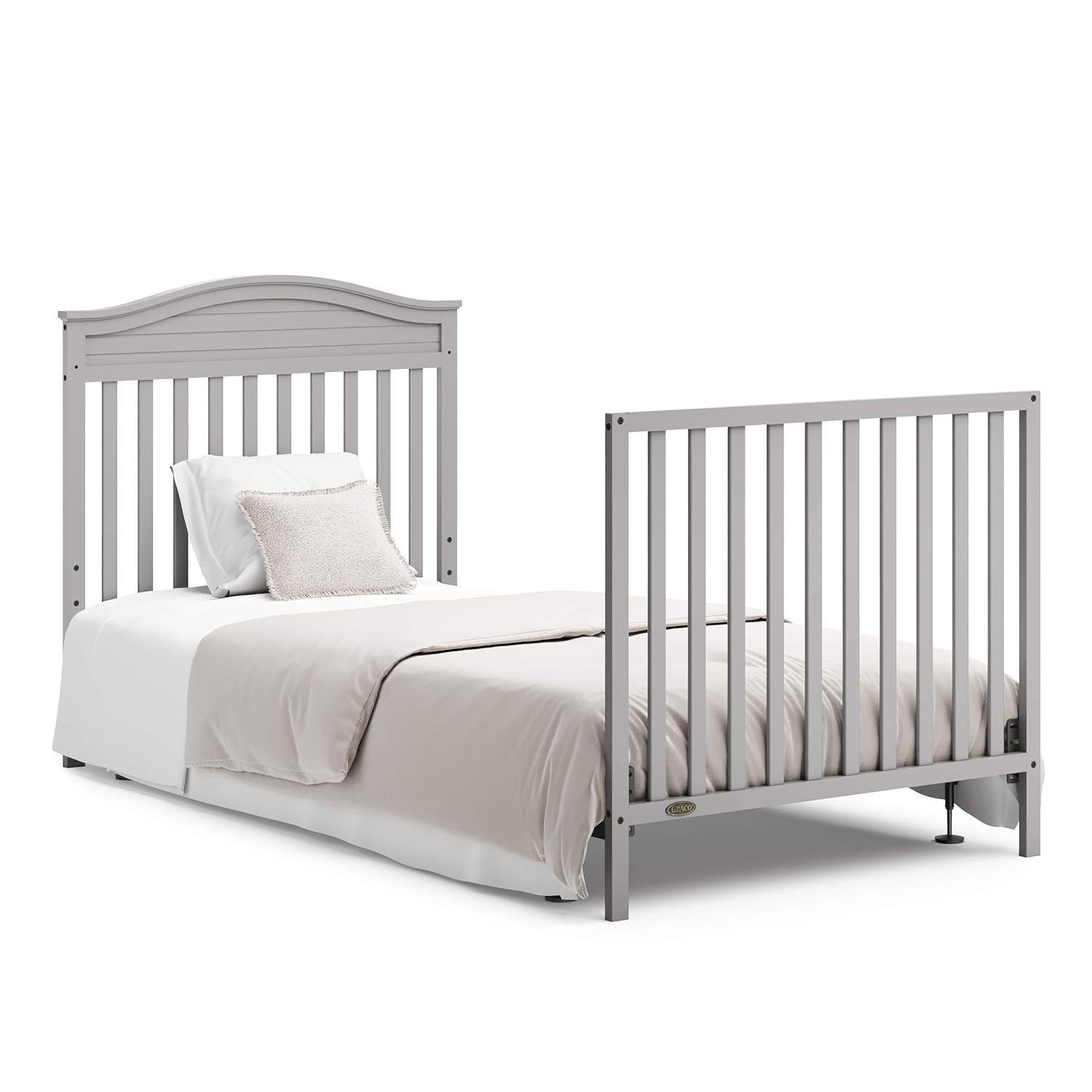 imageGraco Stella 4in1 Convertible Mini Crib with Bonus Mattress Pebble Gray Includes Bonus 275 Inch Thick Mattress with WaterResistant Cover Converts to Twin Bed Ideal Crib for Small SpacesPebble Gray