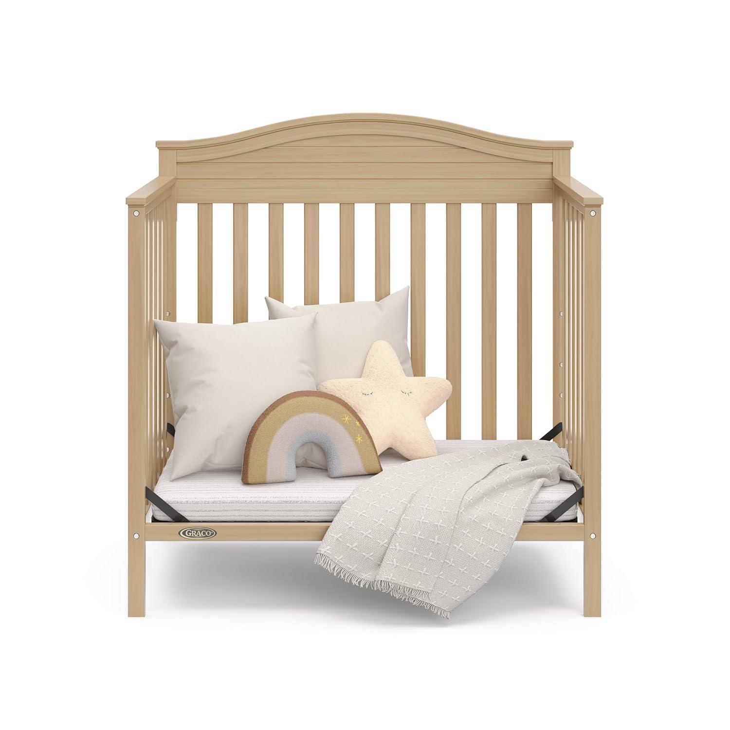 imageGraco Stella 4in1 Convertible Mini Crib with Bonus Mattress Pebble Gray Includes Bonus 275 Inch Thick Mattress with WaterResistant Cover Converts to Twin Bed Ideal Crib for Small SpacesDriftwood