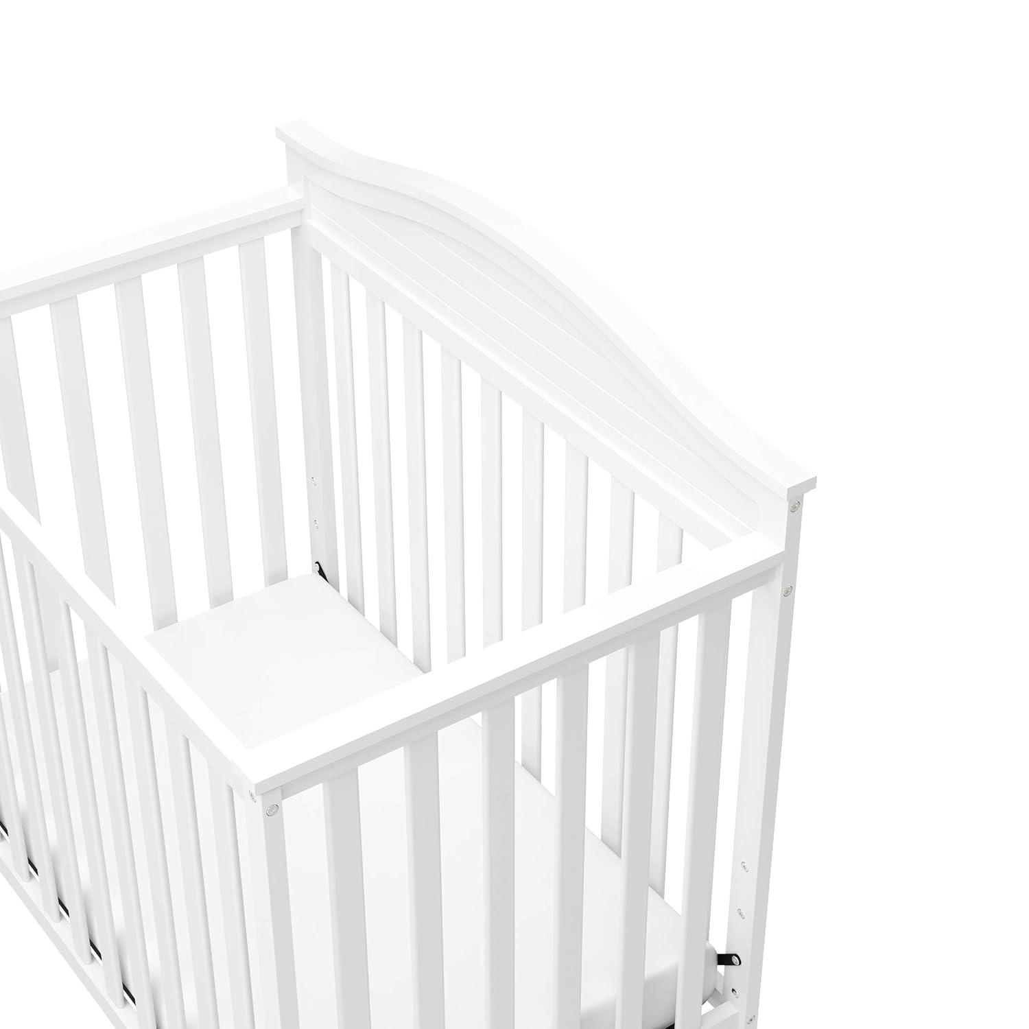 imageGraco Stella 4in1 Convertible Mini Crib with Bonus Mattress Pebble Gray Includes Bonus 275 Inch Thick Mattress with WaterResistant Cover Converts to Twin Bed Ideal Crib for Small SpacesWhite