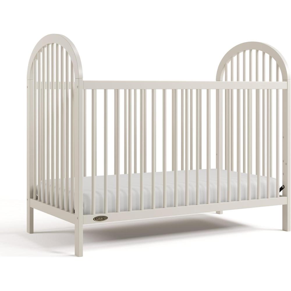 imageGraco Olivia Convertible Crib Hazelnut GREENGUARD Gold Certified 100 Solid Wood Fits Standard Crib Mattress Converts to Toddler Bed and Daybed 4 Adjustable Mattress HeightsFrosted Oat