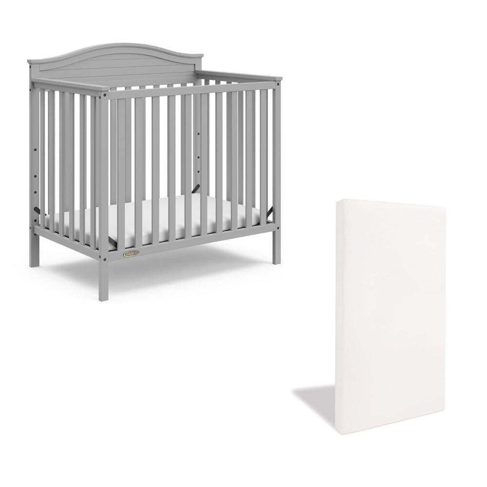 imageGraco Stella 4in1 Convertible Mini Crib with Bonus Mattress Pebble Gray Includes Bonus 275 Inch Thick Mattress with WaterResistant Cover Converts to Twin Bed Ideal Crib for Small SpacesPebble Gray