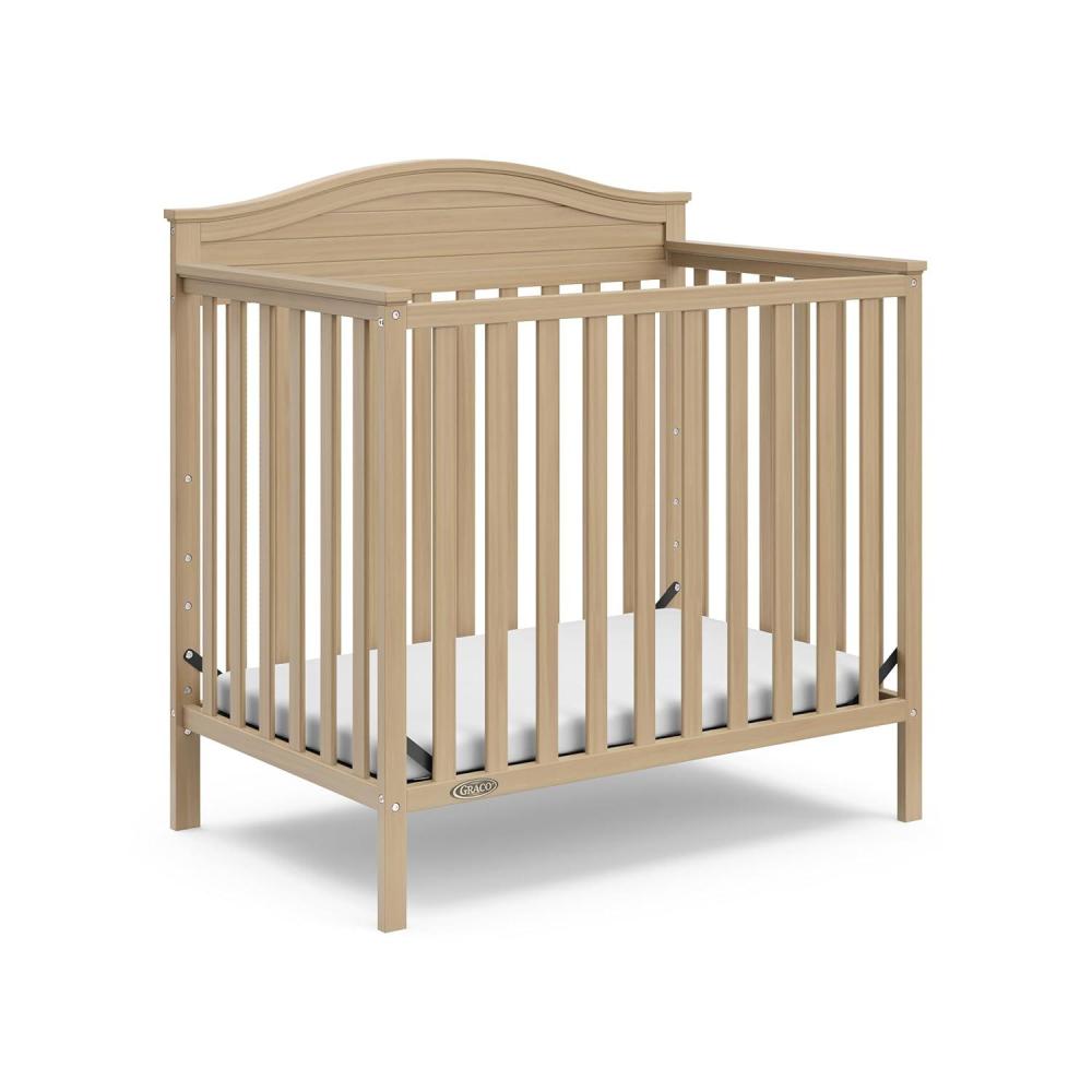 imageGraco Stella 4in1 Convertible Mini Crib with Bonus Mattress Pebble Gray Includes Bonus 275 Inch Thick Mattress with WaterResistant Cover Converts to Twin Bed Ideal Crib for Small SpacesDriftwood
