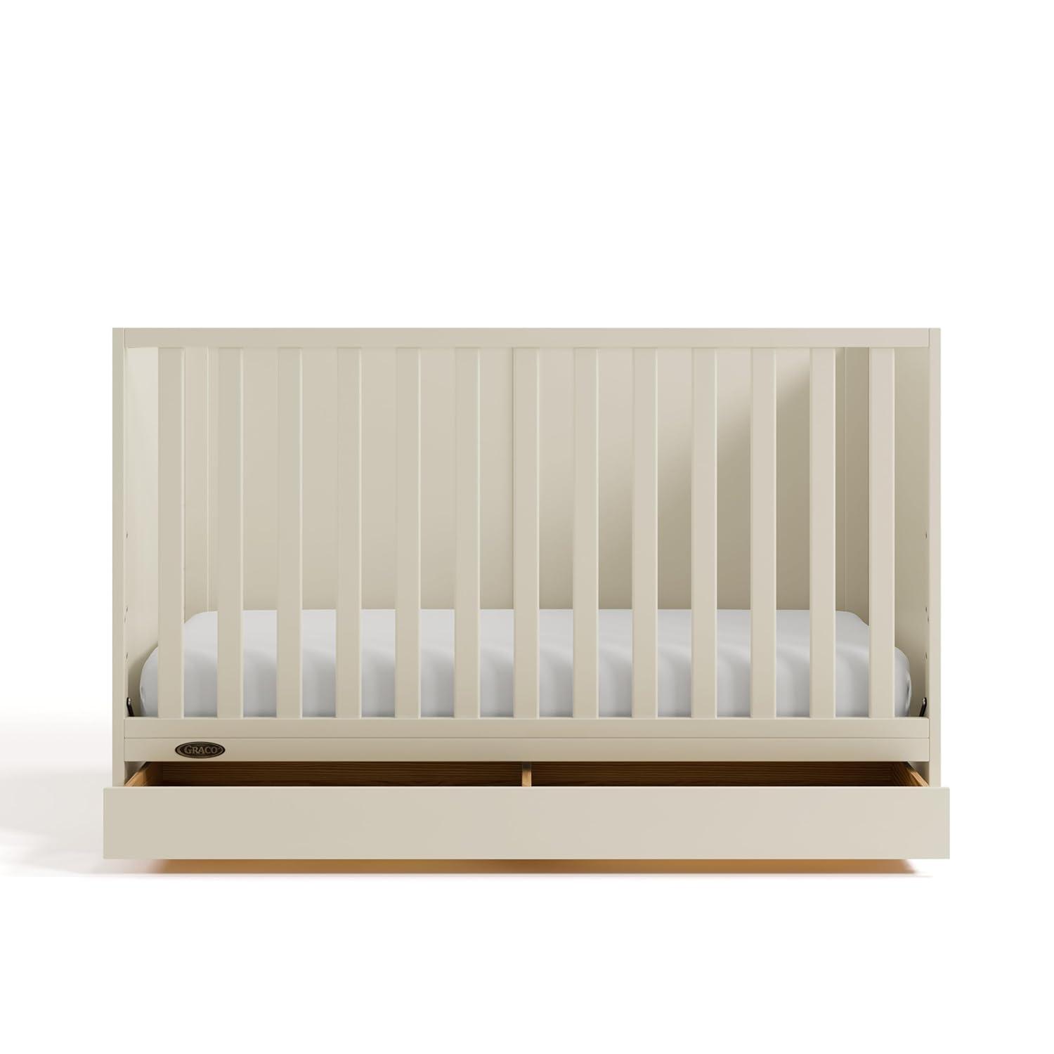 imageGraco Theo Convertible Crib with Storage Drawer Frosted Oat GREENGUARD Gold Certified Wooden Baby Crib with Drawer Converts to Toddler Bed Fits Standard Crib MattressFrosted Oat