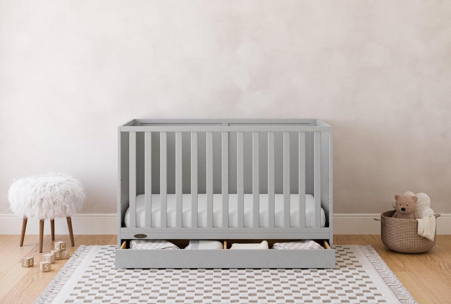 imageGraco Theo Convertible Crib with Storage Drawer Frosted Oat GREENGUARD Gold Certified Wooden Baby Crib with Drawer Converts to Toddler Bed Fits Standard Crib MattressPebble Gray