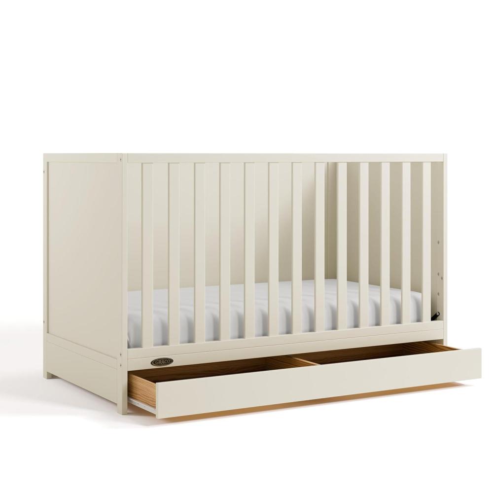 imageGraco Theo Convertible Crib with Storage Drawer Frosted Oat GREENGUARD Gold Certified Wooden Baby Crib with Drawer Converts to Toddler Bed Fits Standard Crib MattressFrosted Oat